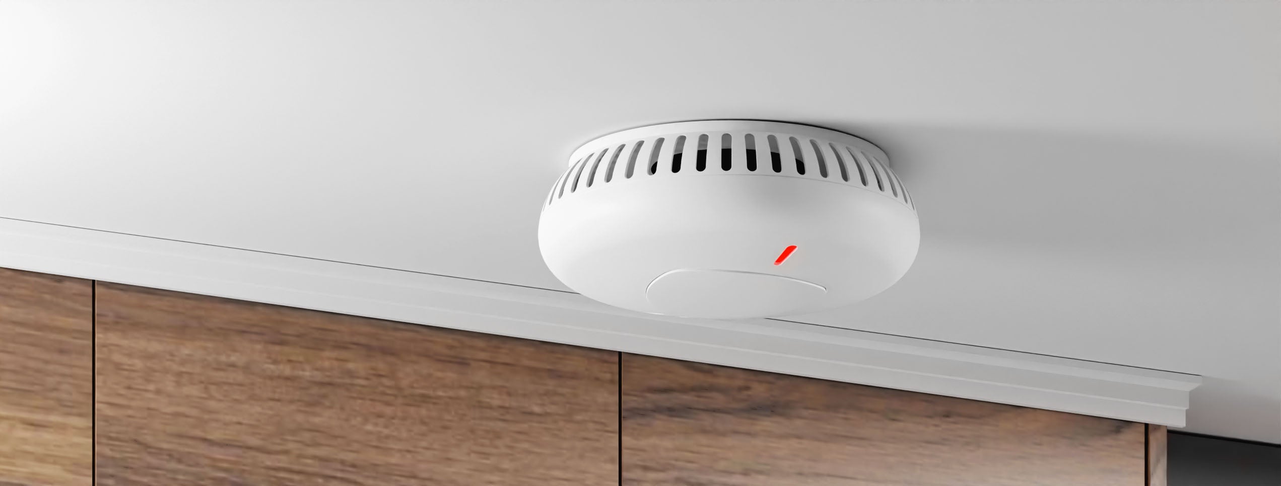 Staniot SK030, Smart Photoelectric Smoke Alarm positioned on ceiling with wooden drawers appearing near the back