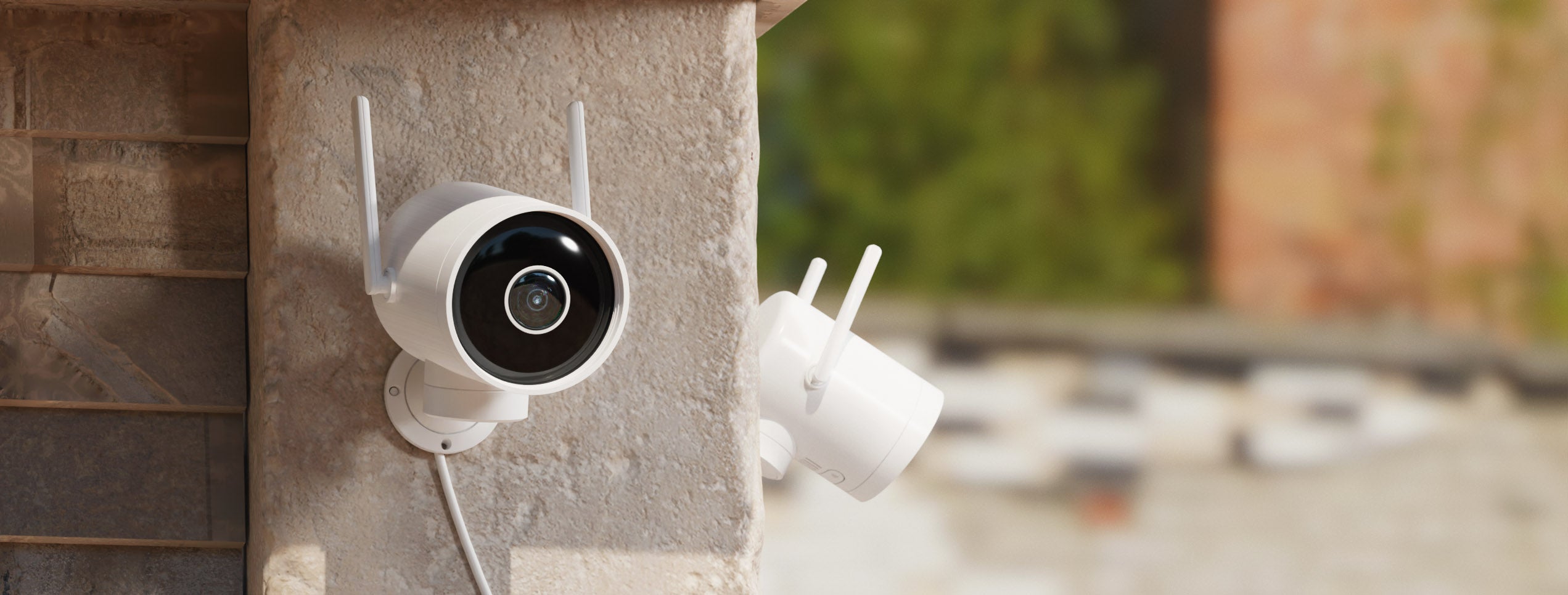 EC3-security-cameras-mounted-in-the-corner-of-a-house-concrete-wall-facing-outside