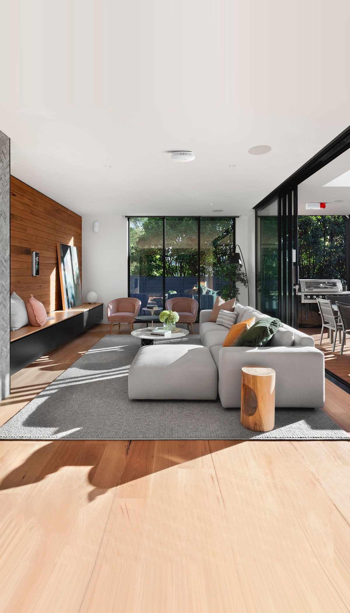 Interior shot of parkdale house Balwyn by R Architecture showing elegant living room with large grey sofa on wooden floor